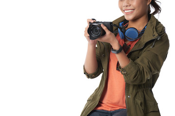 Cropped image of cheerful young woman taking photos during her vacation