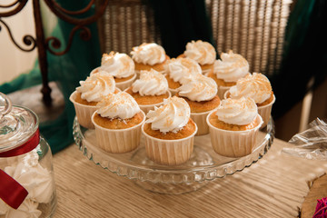 Candy bar. White wedding cake standing of festive table with deserts, tartlet and cupcakes. Wedding.