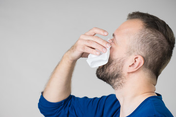 Man blowing nose