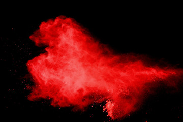 red powder explosion isolated on black background