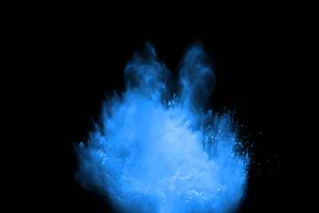 abstract blue powder splatted background. Colorful powder explosion on black background. Colored...