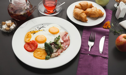 Restaurant breakfast with bacon and fried eggs