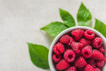 Fresh raspberries in a white bowl, raspberry with green leaf