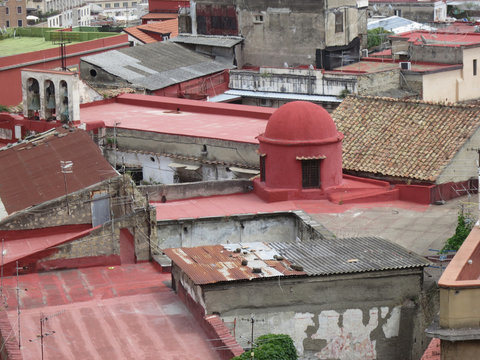 rooftops of houses in Napels, in Italy with a little red dome