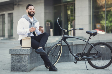 Young business man eating his lunch outdoors