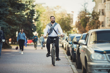 Young businessman going to work by bicycle