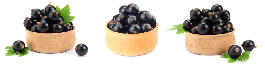 black currant in wooden bowl with green leaf isolated on white background