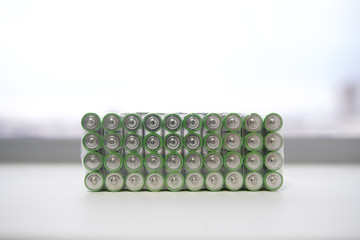 Electric batteries and accumulators size AAA AA lot of green in the package in the store. Shallow...