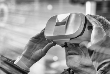 Excited young man wearing a pair of VR glasses exploring Times Square