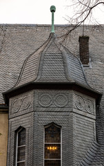 Completely covered with black slate from small slate slabs past the old district court in the old town of the Harz city.