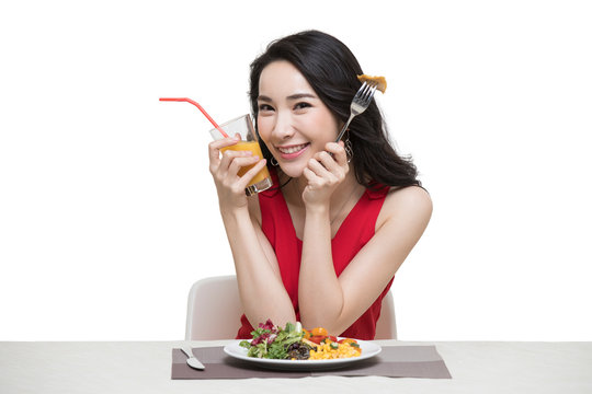 Fashionable young woman eating vegetable salad