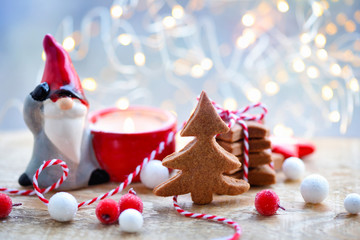Christmas cookies with christmas decorations against the background of festive lights. Christmas or New Year greeting card.