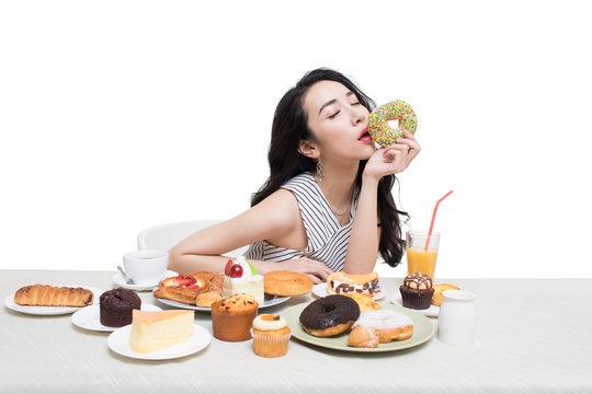 Fashionable young woman eating dessert