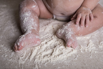 Fototapeta premium baby legs in flour on the table
