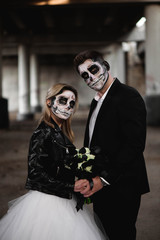 Halloween couple. Dressed in wedding clothes romantic zombie