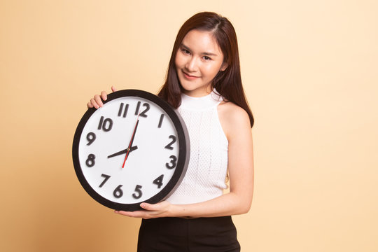 Young Asian woman with a clock.