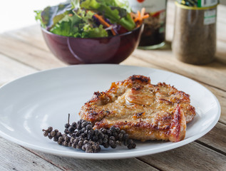 Pork neck steak with vegetables and pepper