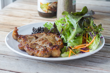 Pork neck steak with vegetables and pepper