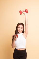 Healthy Asian woman with dumbbell and  tomato juice.