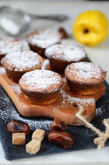 Fototapeta na wymiar Fresh Homemade Quince Muffins sprinkled with powdered sugar. Selective focus.