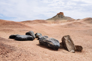 Black rocks and the ruins of ancient watchtower at the historical site of Yang Pass, in Yangguan, Gansu, China