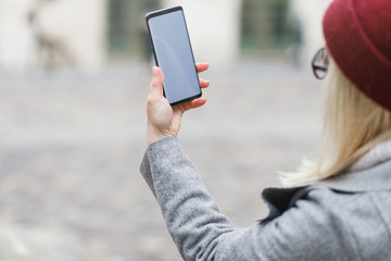 Beautiful girl using smart phone in the city.