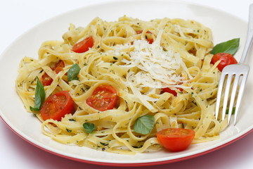 Tagliatelle with pesto tomatoes and fork