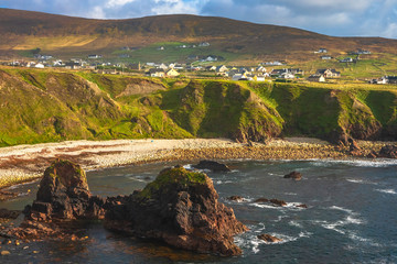 Dramatic coastal landscape at Bloody Foreland, Donegal, Ireland. Natural red granite cliffs at sunset on the Wild Atlantic Way