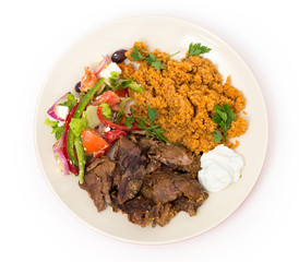 roast lamb kuzu tandir, served with bulgur pilaf and a tossed Turkish salad, all mainstays of...