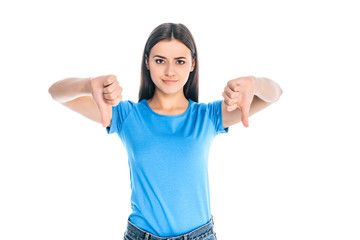 portrait of attractive young woman showing thumbs down isolated on white