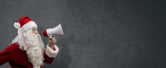 Santa Claus announcing a message with a megaphone