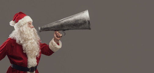 Santa Claus shouting with a vintage megaphone