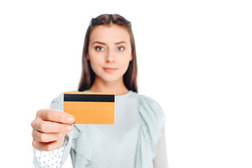 Fototapeta premium portrait of young woman showing credit card isolated on white