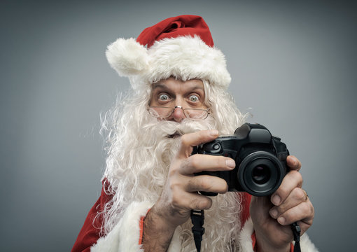 Santa Claus taking holiday pictures