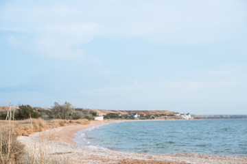 Background of a secluded sandy beach in pastel shades.