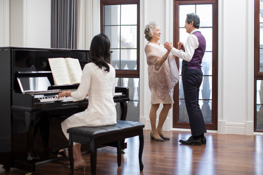 Noble family dancing and playing the piano - Powered by Adobe