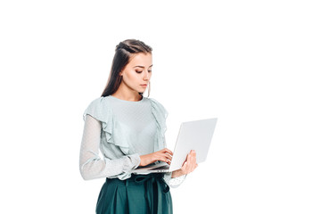 side view of young woman using laptop isolated on white