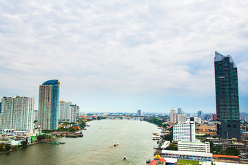 High-rise buildings with the Chao Phraya River and green spaces in Bangkok,Thailand.