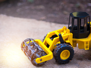 Rice combine harvester. Close up of yellow rice combine harvester tractor model on the ground....