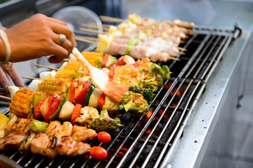 Grilled pork with BBQ sauce on sticks, thailand street food