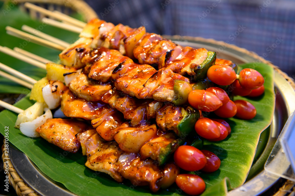 Wall mural Grilled pork with BBQ sauce on sticks, thailand street food