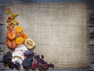 Dried fruits on jute empty background with free space
