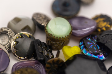 vintage retro buttons from grandmother's chest, poured on a white background