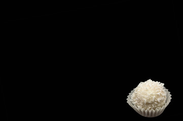 Candy sweet white cream with coconut isolate on a black background