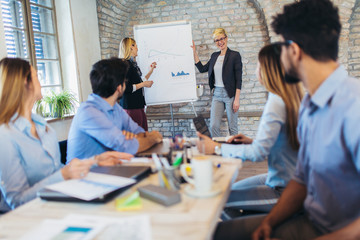 Business colleagues in conference meeting room during presentation