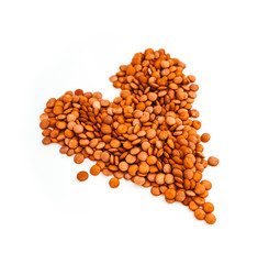 Lentil grains in a shape of heart, isolated on white background. Love to cooking and tasting food, gastronomic journey concept.