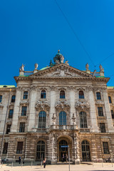 Close view of the southern façade of the Munich Palace of Justice (Justizpalast). The avant-corps is crowned by a gable with the Bavarian coat of arms & on the pediment stands the statue of Justitia.