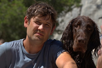 The owner of the dog and the dog are very similar to each other. Sit hugging.