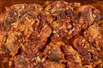 Juicy baked meat in a glass cookware, close-up
