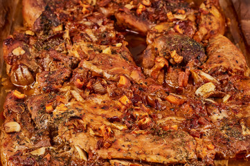 Juicy baked meat in a glass cookware, close-up